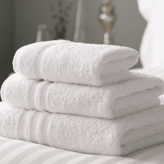 Stack of white commercial terry towels manufactured in Pakistan